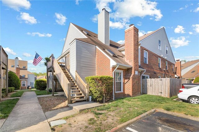 5081 Gatehouse Way, Virginia Beach, VA 23455 - view of home's exterior featuring uncovered parking, stairway, brick siding, a chimney, and fence