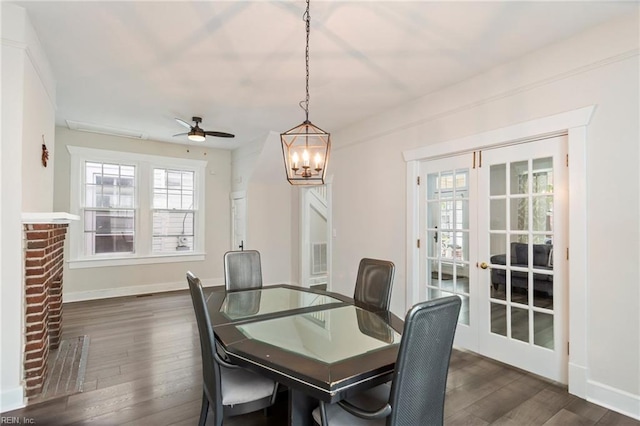 dining room featuring dark wood finished floors, baseboards, ceiling fan with notable chandelier, and french doors
