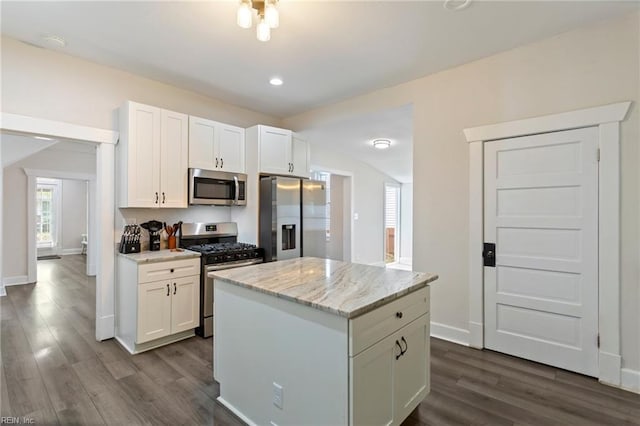kitchen with white cabinetry, stainless steel appliances, and dark wood finished floors