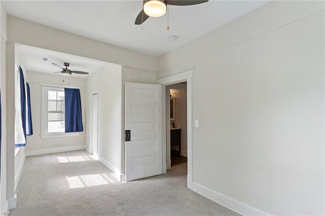 spare room with baseboards, ceiling fan, and carpet floors