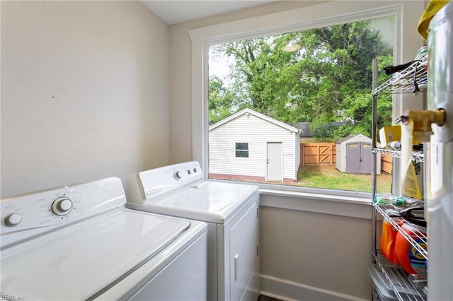 laundry area with baseboards, washer and dryer, and laundry area