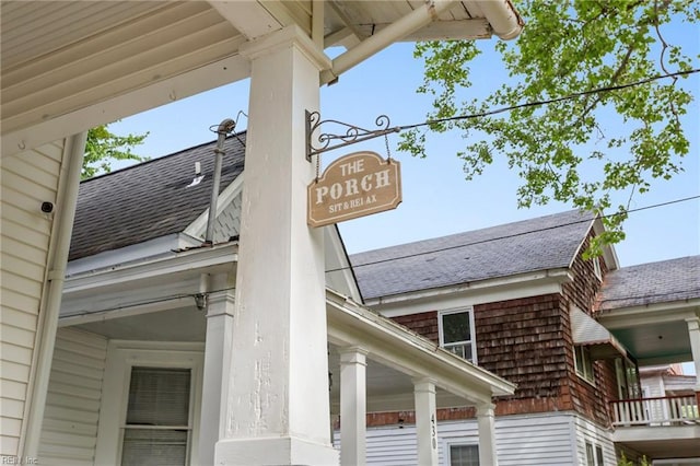 details featuring decorative columns and roof with shingles