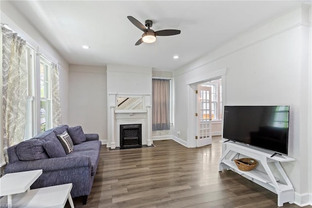 living room featuring recessed lighting, wood finished floors, baseboards, a ceiling fan, and a fireplace with flush hearth