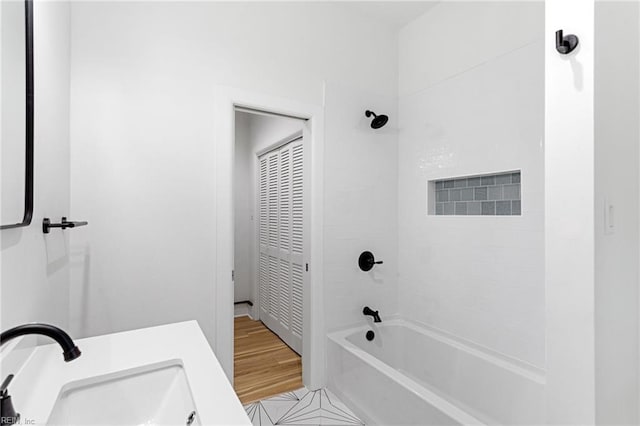bathroom with shower / tub combination and a sink