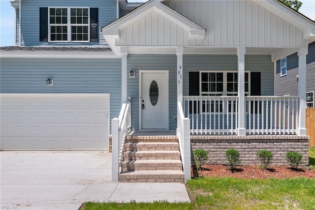 property entrance with driveway and covered porch