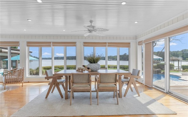 sunroom / solarium featuring recessed lighting, plenty of natural light, and wood finished floors