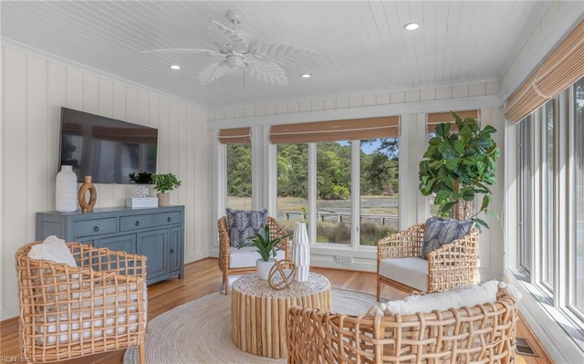 sunroom with crown molding, recessed lighting, a wealth of natural light, and wood finished floors