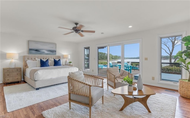 bedroom featuring baseboards, access to outside, recessed lighting, and wood finished floors
