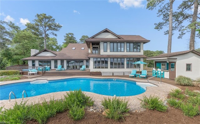 rear view of house featuring a fenced in pool, stucco siding, a chimney, and a patio