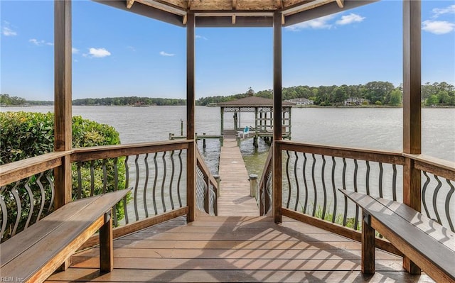 dock area with a water view and boat lift