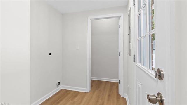 interior space featuring light wood finished floors and baseboards