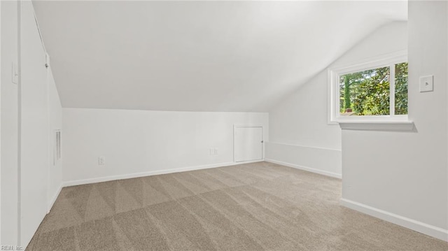 bonus room featuring lofted ceiling, baseboards, and carpet floors