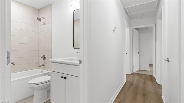 full bathroom featuring vanity, toilet, baseboards, tub / shower combination, and wood finished floors