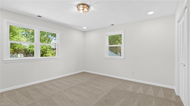 carpeted empty room featuring recessed lighting, baseboards, and a healthy amount of sunlight