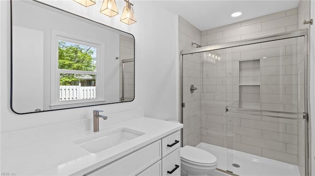 full bath featuring toilet, recessed lighting, a shower stall, and vanity