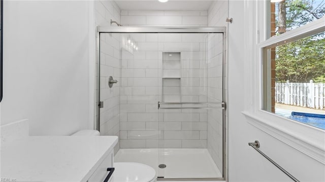 full bath featuring a stall shower and toilet