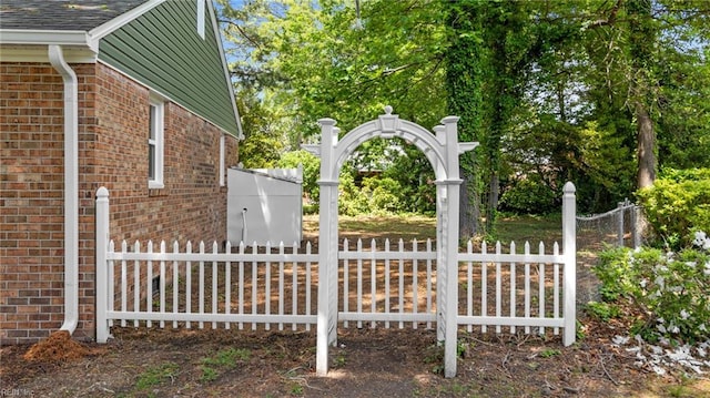 view of side of property with fence and brick siding