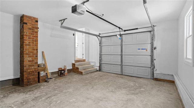 garage featuring a garage door opener and baseboards