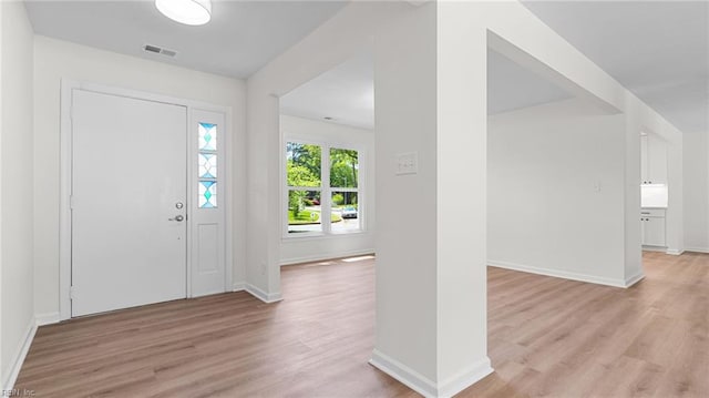entrance foyer featuring baseboards, visible vents, and light wood-type flooring