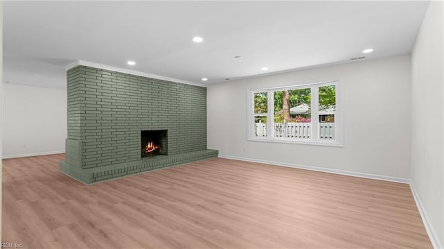 unfurnished living room featuring a fireplace, light wood-type flooring, recessed lighting, and baseboards