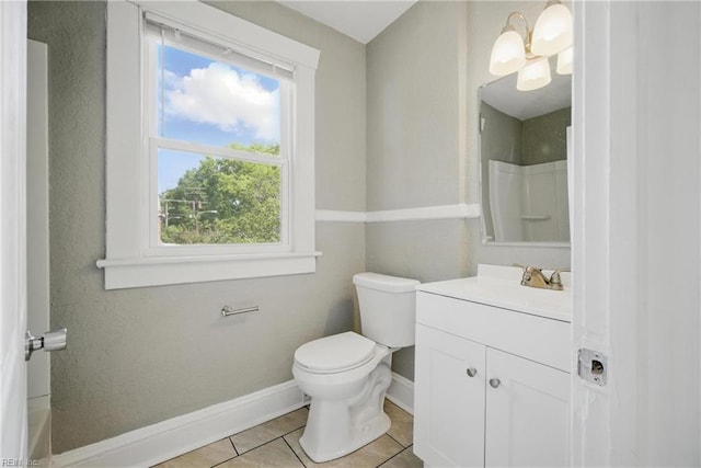 bathroom with walk in shower, tile patterned floors, toilet, vanity, and baseboards
