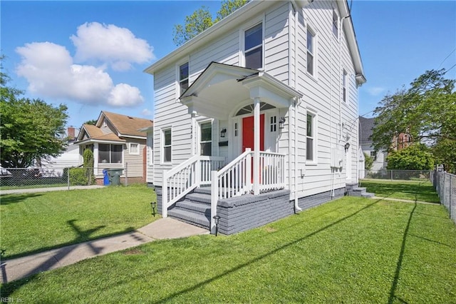 view of front of house featuring a fenced backyard and a front lawn