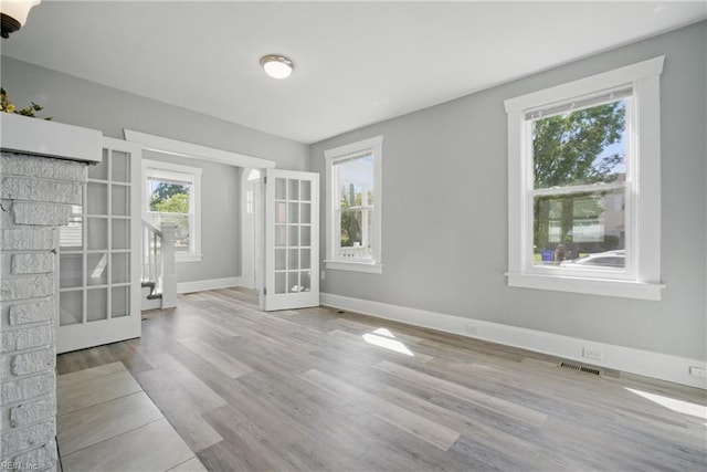 interior space featuring visible vents, french doors, and a healthy amount of sunlight