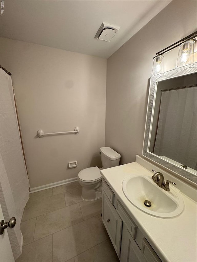 full bath with tile patterned floors, toilet, vanity, baseboards, and visible vents