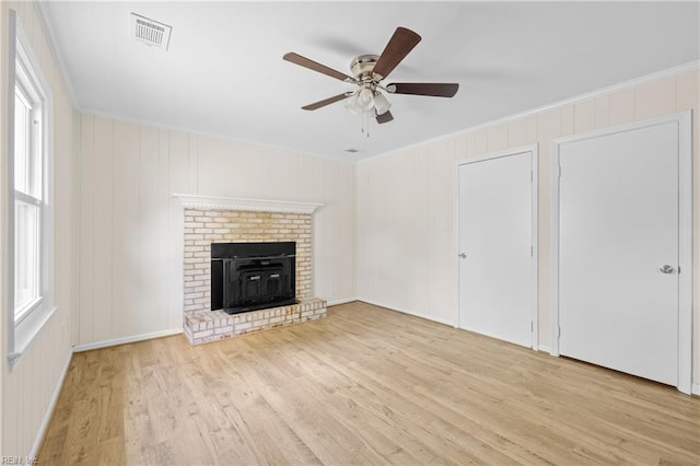 unfurnished living room featuring visible vents, wood finished floors, a ceiling fan, and crown molding