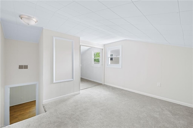 additional living space featuring visible vents, carpet flooring, and baseboards