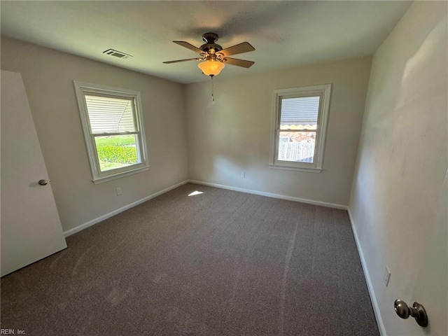 empty room with ceiling fan, plenty of natural light, baseboards, and carpet floors