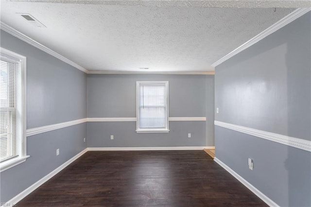 empty room featuring baseboards, wood finished floors, a textured ceiling, and ornamental molding