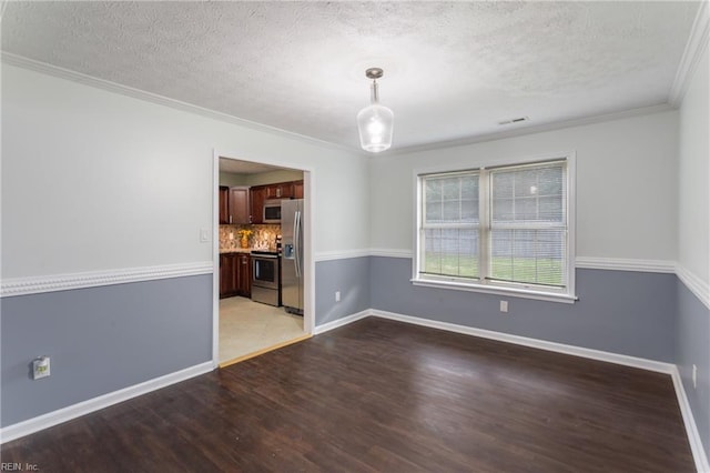 empty room with crown molding, a textured ceiling, visible vents, and light wood-type flooring