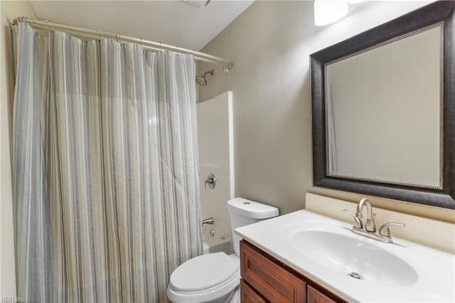 bathroom featuring shower / tub combo, vanity, and toilet