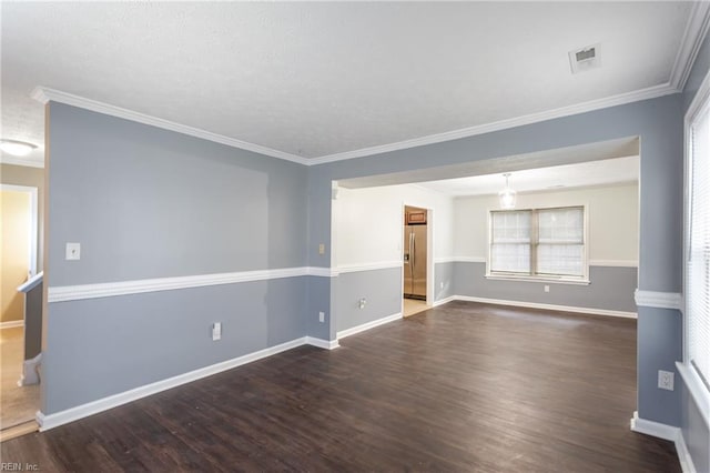 unfurnished room with baseboards, visible vents, and wood finished floors