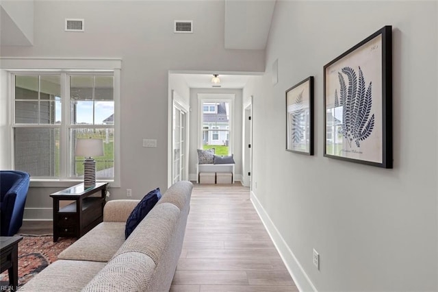 interior space featuring wood finished floors, visible vents, and baseboards
