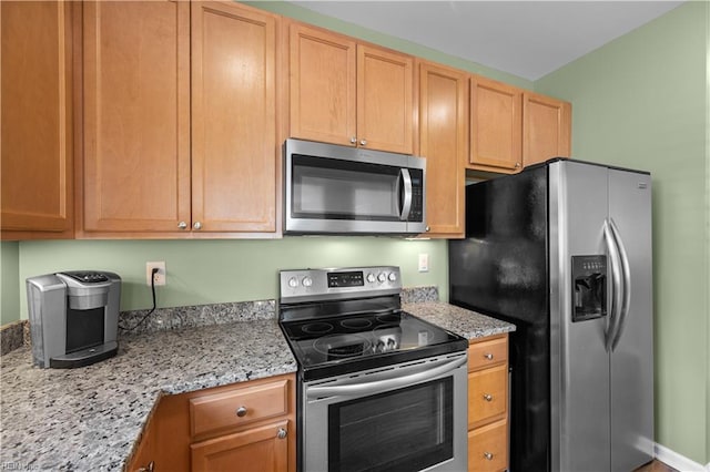 kitchen featuring appliances with stainless steel finishes and light stone countertops