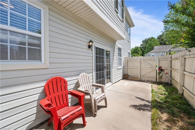 view of patio with fence and a gate