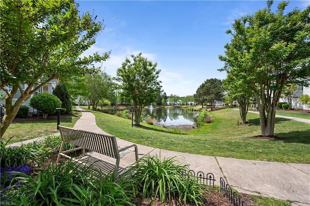 view of home's community featuring a water view and a yard