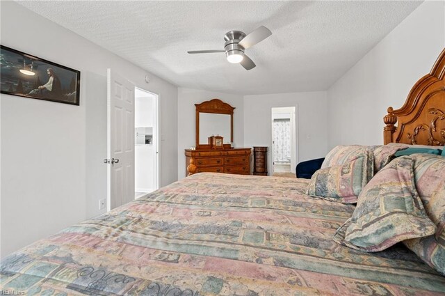 bedroom with a textured ceiling and a ceiling fan