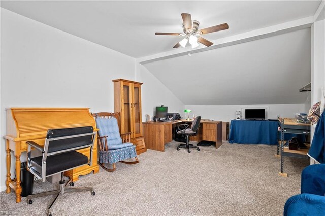 carpeted office with a ceiling fan and vaulted ceiling
