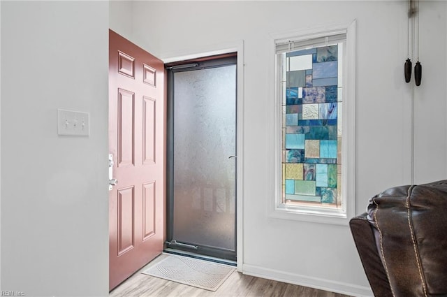 foyer with baseboards and light wood-type flooring