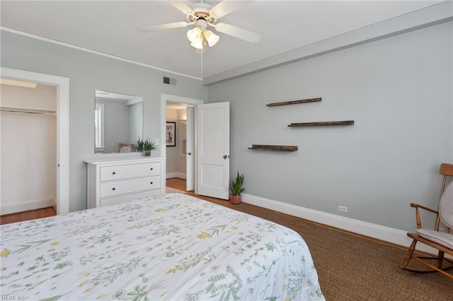 bedroom with baseboards, visible vents, a ceiling fan, and a closet