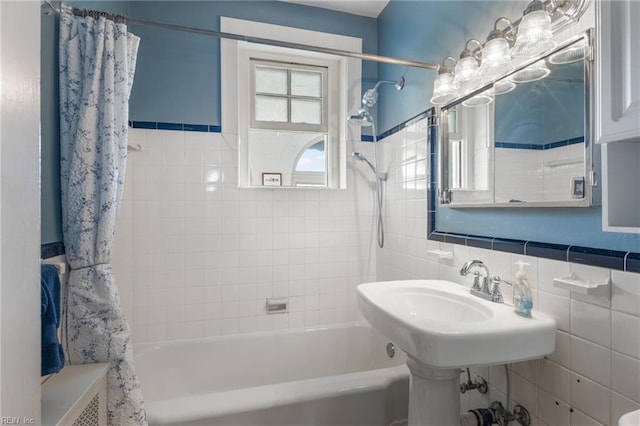 full bathroom featuring shower / tub combo and tile walls