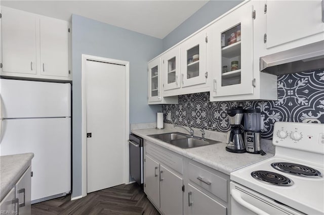 kitchen featuring exhaust hood, a sink, glass insert cabinets, white appliances, and light countertops