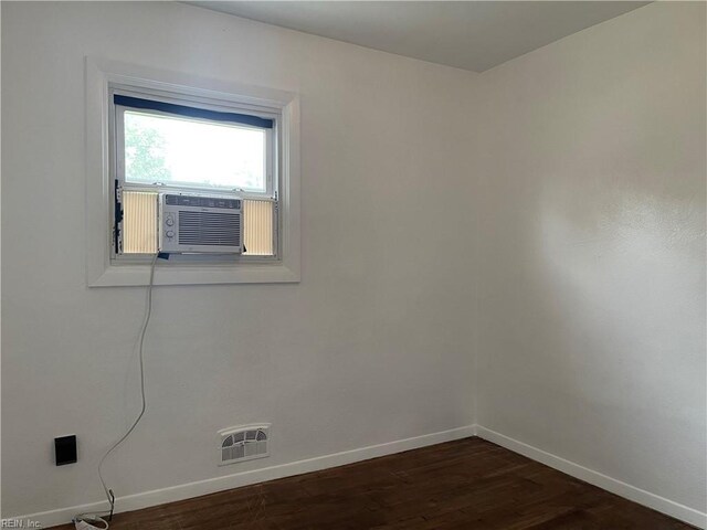7420 Doummar Dr, Norfolk, VA 23518 - spare room featuring baseboards, dark wood-type flooring, and cooling unit
