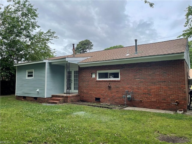 7420 Doummar Dr, Norfolk, VA 23518 - back of house featuring french doors, crawl space, a yard, a shingled roof, and brick siding