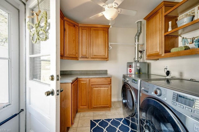 clothes washing area featuring washer and dryer, light tile patterned floors, cabinet space, ceiling fan, and gas water heater