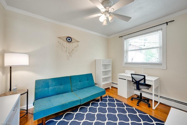 office space featuring a ceiling fan, wood finished floors, a baseboard heating unit, and ornamental molding