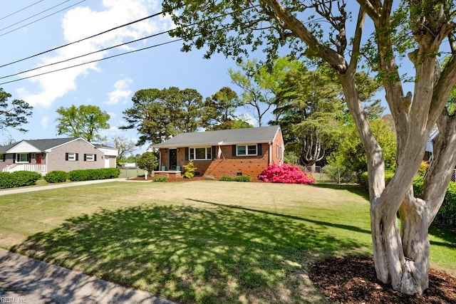 single story home featuring fence, a front lawn, and brick siding